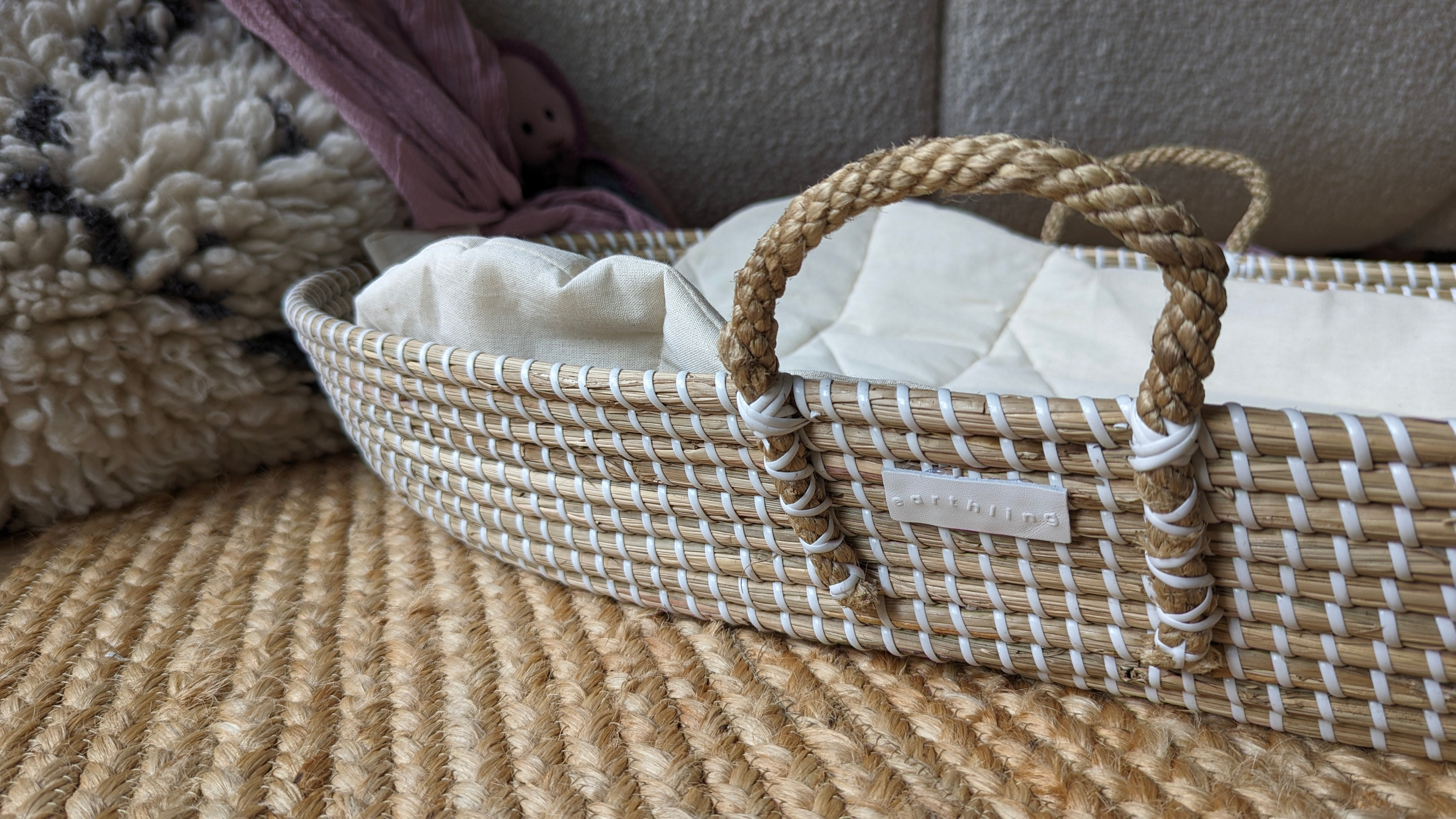 Natural seagrass baby changing basket with neutral decor
