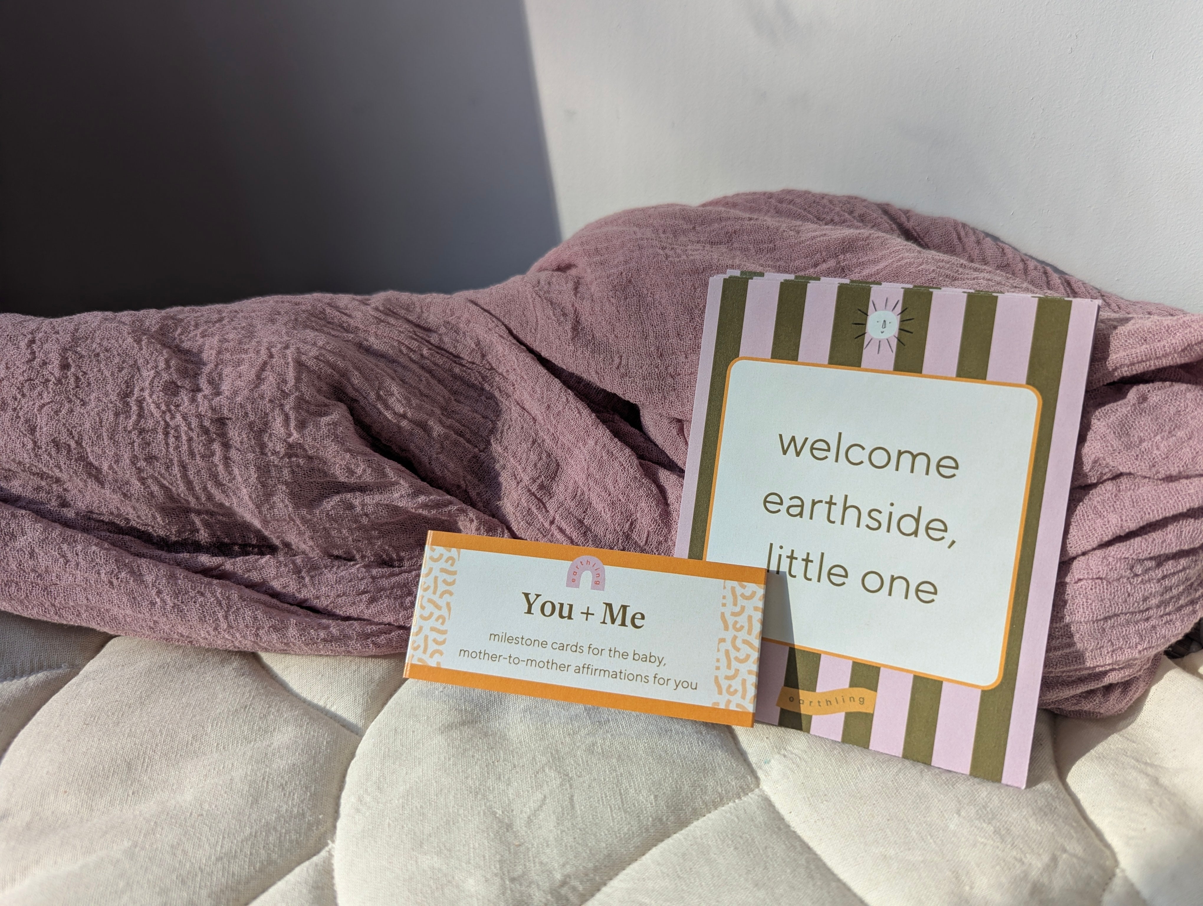 Baby milestone cards on a soft cotton baby liner with blanket