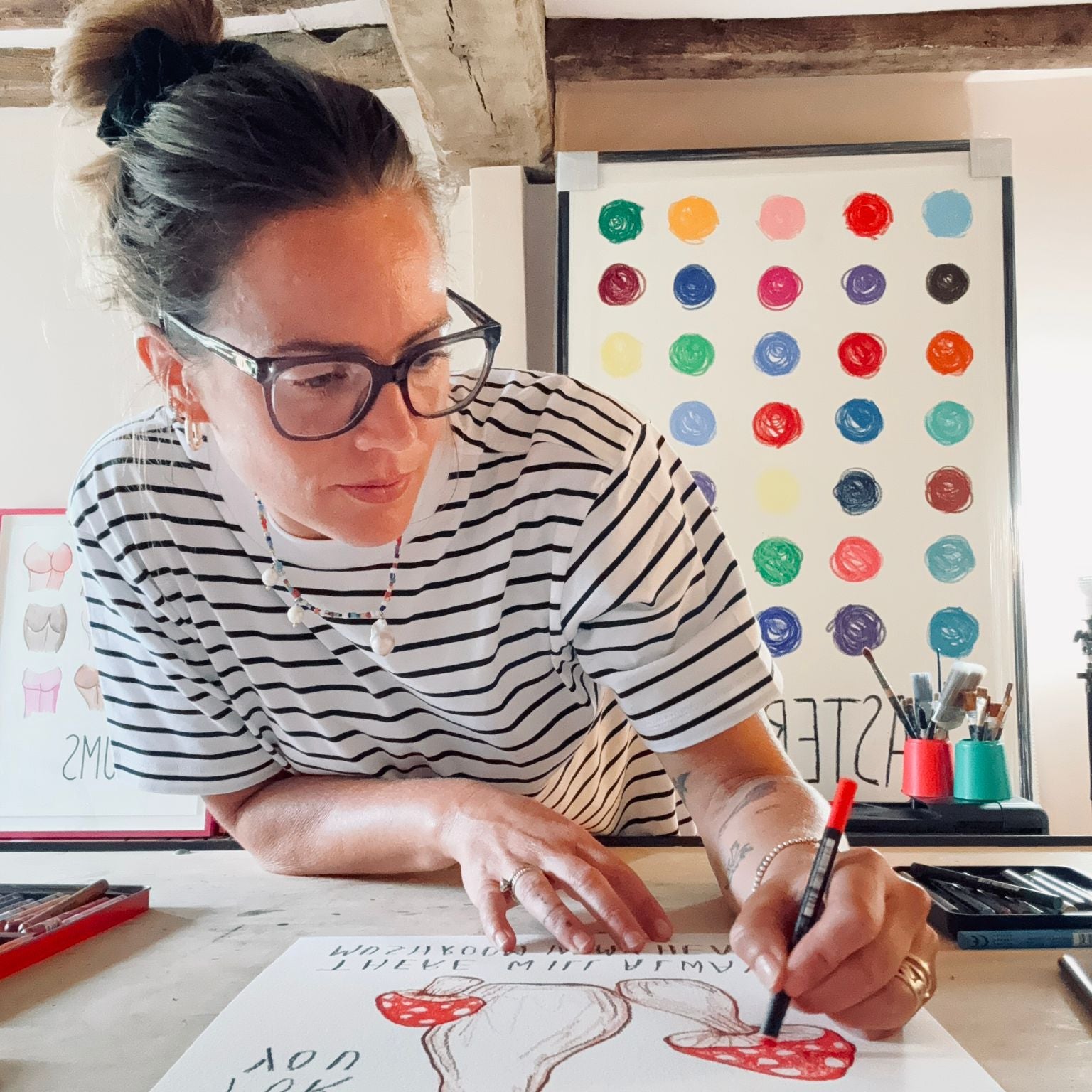 Artist drawing a red toadstool nursery art