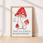 Framed Alma Singer Nursery artwork with red mushrooms and text on a white background