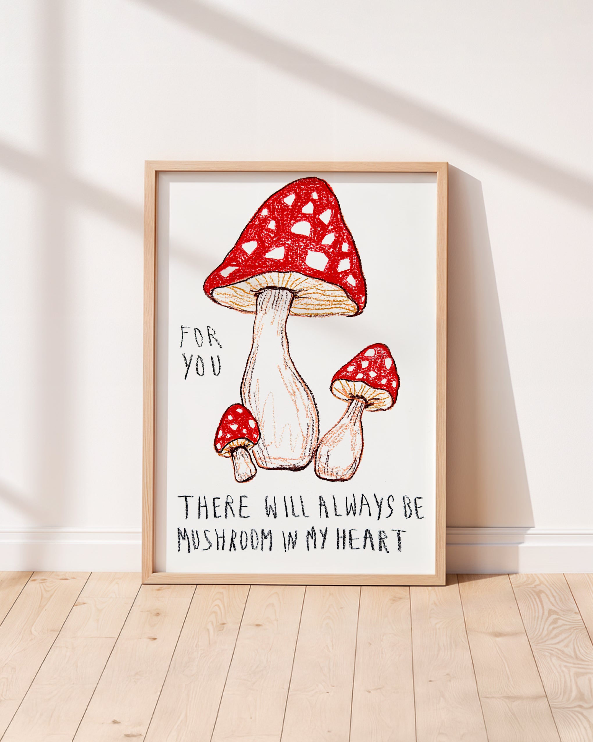 Framed Alma Singer Nursery artwork with red mushrooms and text on a white background