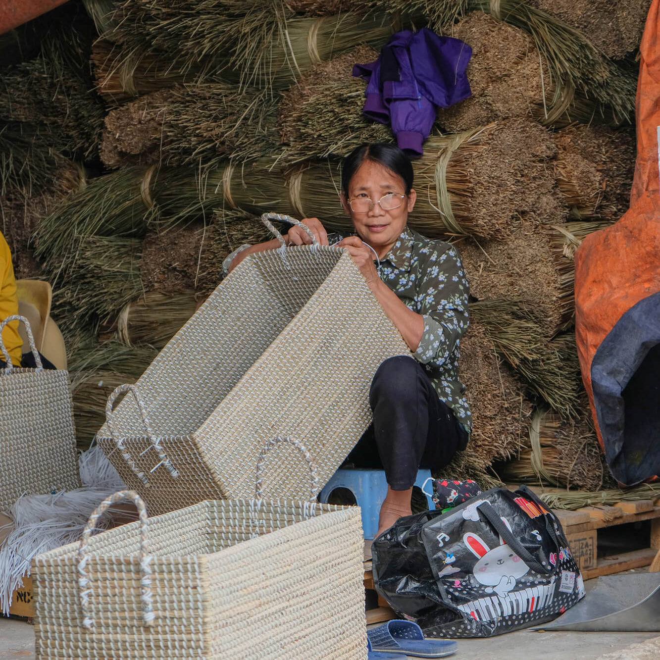 Vietnamese artisan weaving a seagrass basket