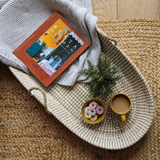 neutral coffee table tray hand woven styled with a cup of tea and party rings