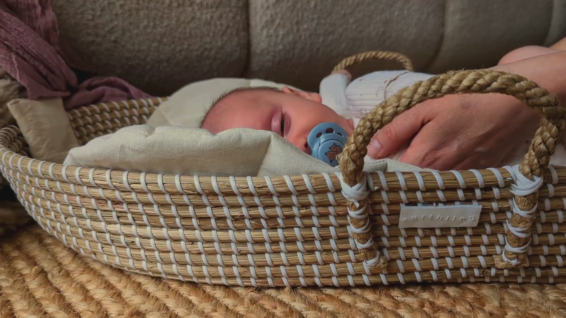Sleepy baby in changing basket